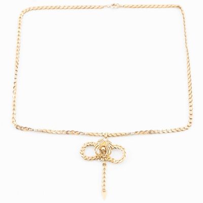 a gold chain necklace with a knot and a cross on it