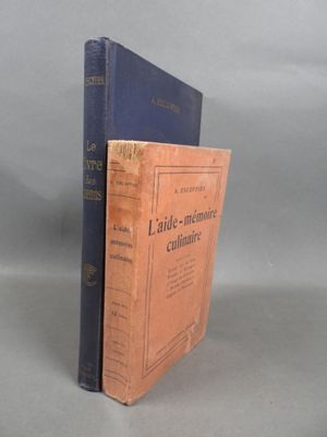 two books sitting on top of each other on a gray surface