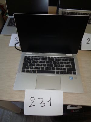 two laptops sitting on a table with a price tag attached to them