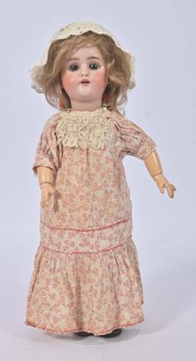 an old fashioned doll with a hat and dress on a white background