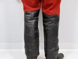 a close up of a mannequin dressed in red pants and black boots