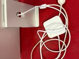 a white cable connected to a white charger on a red surface