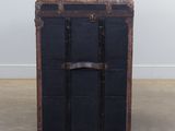 a black trunk sitting on the floor in a room