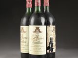three bottles of wine sitting on top of a table next to each other