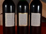 three bottles of wine sitting on a table next to each other