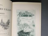 an open book on a table with a drawing of a boat in the water