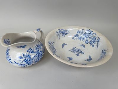 un bol et une soucoupe bleus et blancs posés sur une table blanche