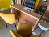 two yellow chairs sitting in front of a yellow counter