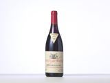 a bottle of red wine sitting on top of a table