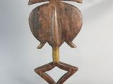 an image of a wooden sculpture of a leaf on a stand