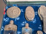 a box with a lot of silver items inside of it