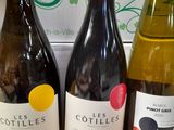 three bottles of wine sitting on a table next to a box of wine