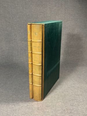 a green book sitting on top of a table next to a gray wall