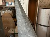 concrete cone sitting on top of a table next to a refrigerator
