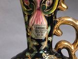 a vase with a floral design on it on a table