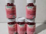 four bottles of collagen gummies sitting on a table
