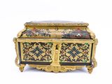 a gold and black box with flowers on it