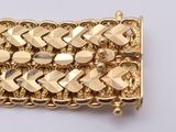 an image of a close up of a gold bracelet on a white surface