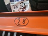 an orange shelf with a tire and a bag of energy