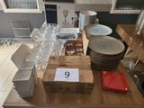 a table with a lot of wine glasses and plates on it