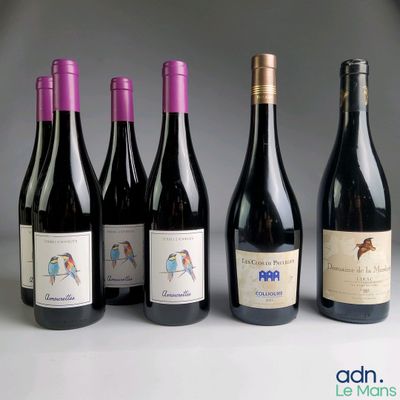 several bottles of wine are lined up on a table