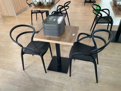 a table and chairs in a room with wood flooring