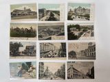 many old postcards of different cities on the wall