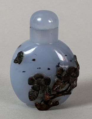 a small glass bottle with a bird on it