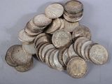 a pile of silver coins sitting on a table