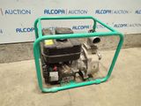 a small water pump sitting on the ground in front of a wall