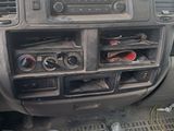 a dashboard of a car with a clock and other items in it