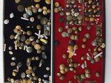 beaucoup de boutons dans un étui posé sur une table