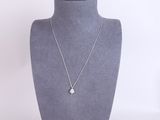 a close up of a necklace on a mannequin with a white background