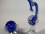 three glass figurines that are sitting on a table