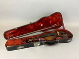 a violin in a case on a white surface