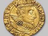 a close up of a gold coin with a crown on it
