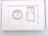 a white box with a charger and a cable in it