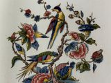 a picture of a plate with a bird and flowers on it