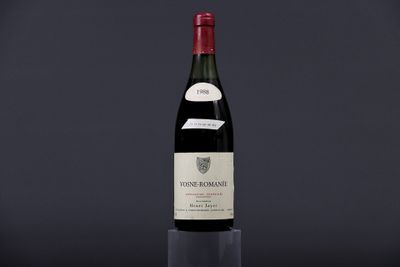 a bottle of wine sitting on top of a glass table