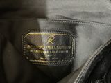 the label on the back of a black leather purse