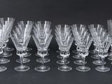 many empty wine glasses lined up on the table