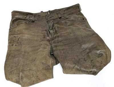 an old pair of brown pants with a hole in the side