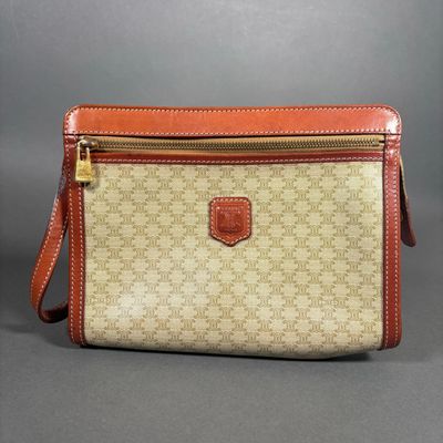 a beige and brown purse with a brown strap