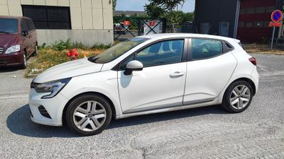 a picture of a white car parked in front of a building