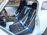 two seats in the back of a car with a steering wheel
