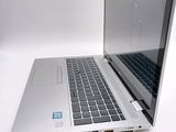 a laptop that is open on a white surface