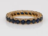 a yellow gold ring with blue sapphires and diamonds