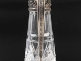 a close up of a silver and crystal vase on a table