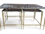 two tables with glass tops and gold legs