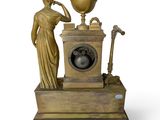 a statue of a woman standing next to a clock